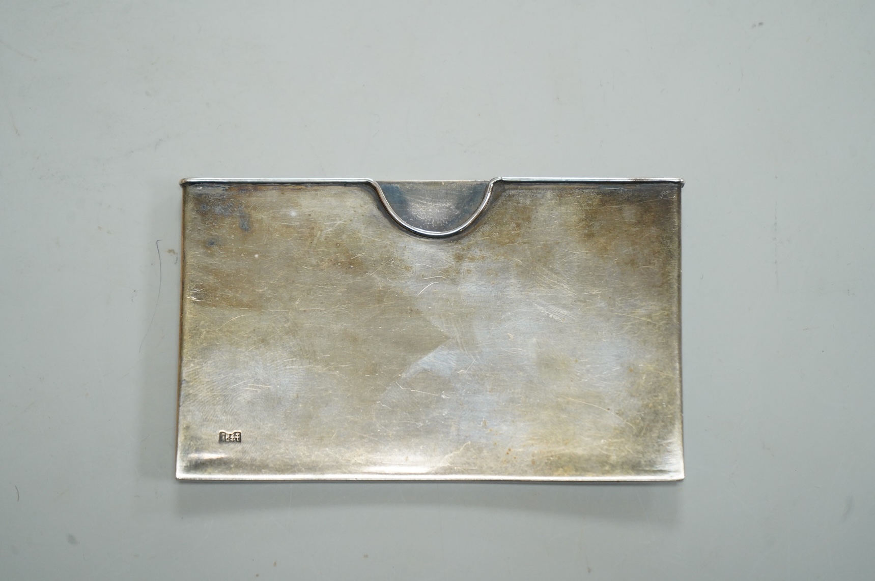 A Japanese Meiji period white metal card case, with applied dragon decoration, jungin mark, 90mm by 55mm.